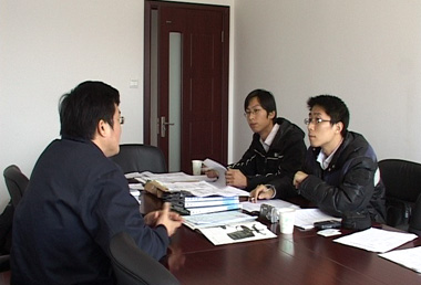 Two SGS auditors (right) auditing documents.