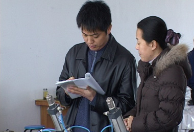 An SGS auditor (left) carefully collecting data.